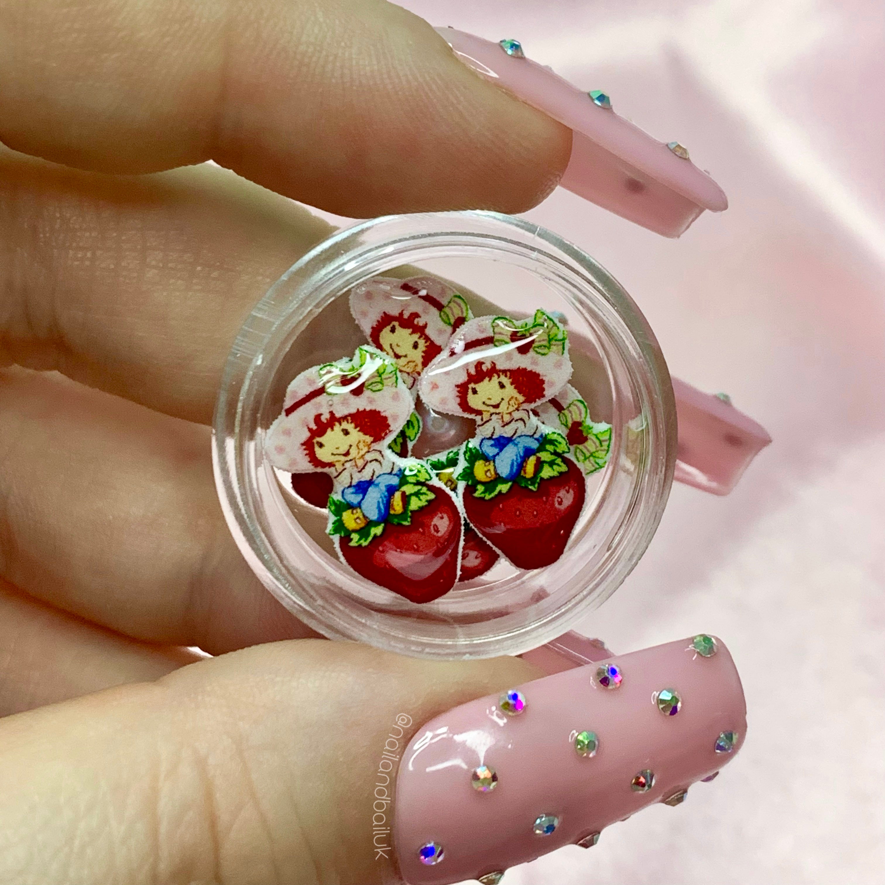 Add a sweet touch to your nails with these adorable Strawberry Shortcake nail charms! These petite charms feature the beloved cartoon character and are perfect for adding some fun and whimsy to your next manicure. With their vibrant colors and cute designs, these Strawberry Shortcake nail charms are sure to bring a smile to your face every time you catch a glimpse of them.